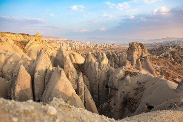 Fototapeta na wymiar Stunning Cappadocia landscape with the rock formations during a beautiful sunset. Red & Rose Valley, Cappadocia, central Anatolia, Turkey
