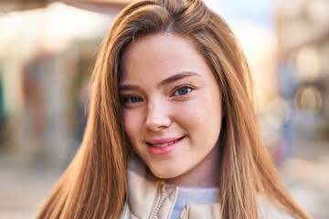 Fototapeta premium Young blonde woman smiling confident standing at street