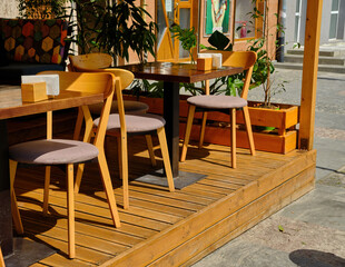 Outdoor street cafe tables ready for service.