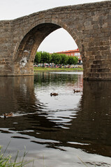 Fototapeta premium Old stone bridge and reflections on the river