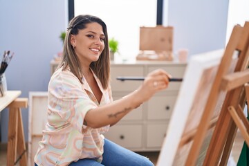 Young hispanic woman artist smiling confident drawing at art studio