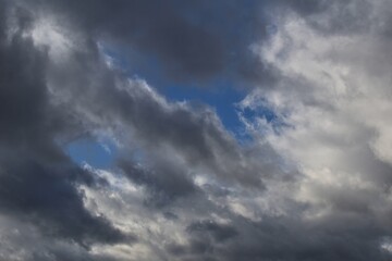 blue sky against dark clouds