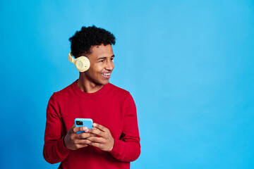 Black man with smartphone listening to music