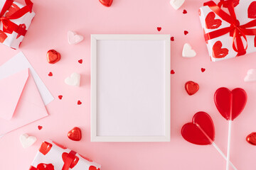 Valentines mood concept. Flat lay photo of gift boxes, heart shaped lollipops, candies and...