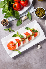 Close-up photo of caprese salad with ripe tomatoes, basil, buffalo mozzarella cheese. Italian and Mediterranean food concept. Fresh and healthy organic meal. Starter and antipasti. 