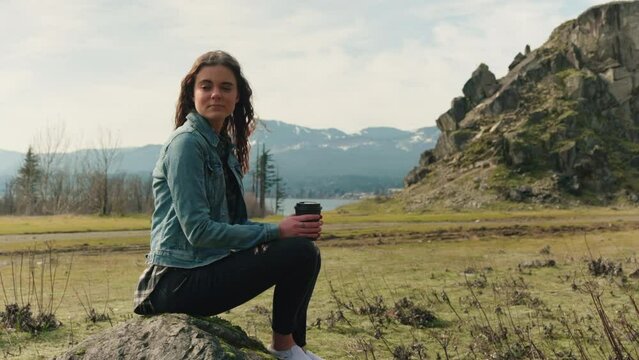 woman in the mountains drinking coffee 