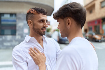 Fototapeta na wymiar Two hispanic men couple smiling confident hugging each other at street