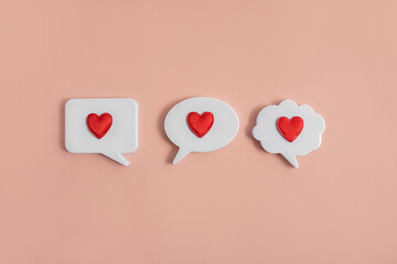 Chat icons with hearts on a light background. The concept of modern dating. Receiving or sending love letters. Dating in the social network. Modern love. Copy space.