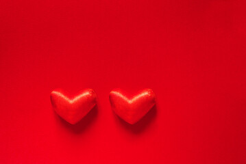 Valentine's day banner with two red hearts on a red background with space for text. love and happiness.	