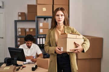 Young two people working at small business ecommerce thinking attitude and sober expression looking self confident