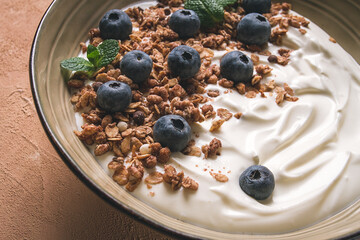 yogurt with chocolate muesli, with berries, blueberries, breakfast, close-up, fork on top, no people,