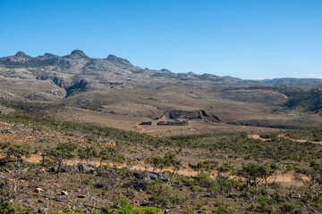 A mountainous landscape in the desert with shrubs