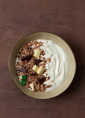 yogurt with chocolate muesli, breakfast, close-up, fork on top, no people,