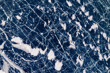 Winter lake Baikal, Abstract background texture of blue ice with cracks, aerial top view