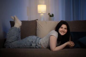 teenager brunette  girl in living room   at night