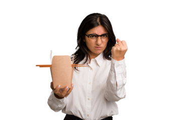 Young business indian woman eating takeaway noodles cut out isolated showing fist to camera, aggressive facial expression.