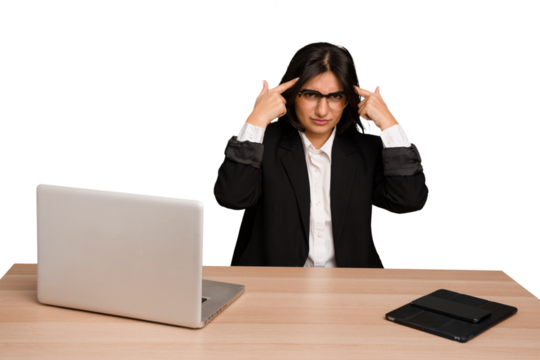 Young indian woman in a table with a laptop and tablet isolated focused on a task, keeping forefingers pointing head.