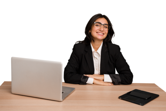 Young indian woman in a table with a laptop and tablet isolated confident keeping hands on hips.