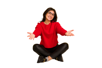Young indian woman sitting on the floor cut out isolated showing a welcome expression.