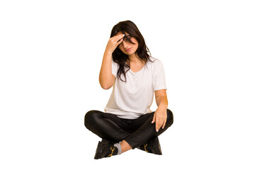 Young indian woman sitting on the floor cut out isolated having a head ache, touching front of the face.