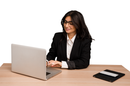 Young indian woman in a table with a laptop and tablet using a mobile phone isolated