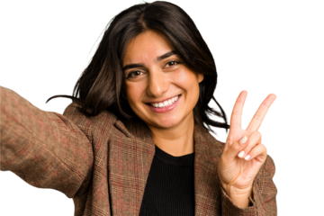 Young indian woman doing a selfie with mobile isolated