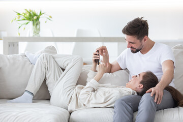 Couple sitting on couch with cell phone