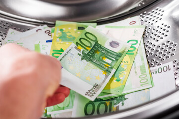 European one hundred euro banknotes in washing machine and in hand