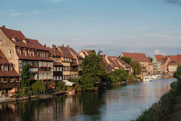 Fototapeta na wymiar view to the historical quarter on the bank of the Regnitz river Bamberg with ship.