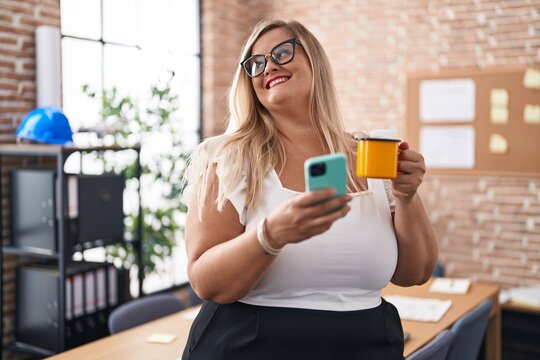 Young woman business worker using smartphone drinking coffee at office