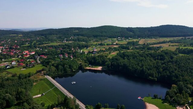 Aerial view of mountain village at summer day. Recreation area near Sleza Mountain with large lake and camping place. Summer outdoor recreation. Beautiful landscape of nature