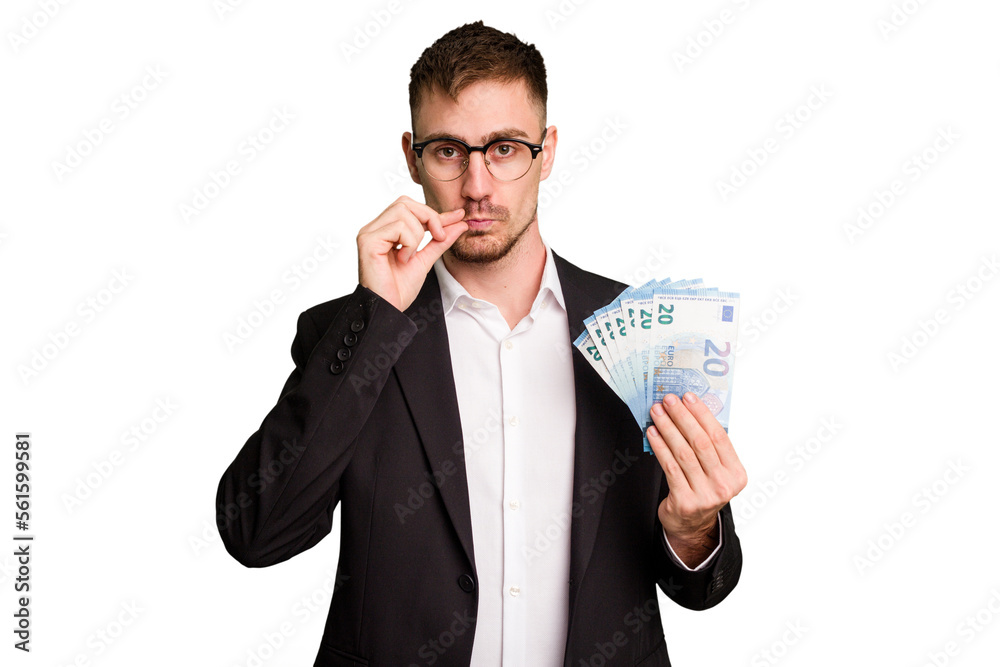 Wall mural Young business caucasian man holding euro banknotes isolated cut out with fingers on lips keeping a secret.