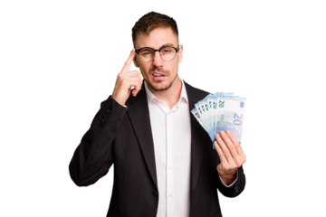 Young business caucasian man holding euro banknotes isolated cut out showing a disappointment gesture with forefinger.