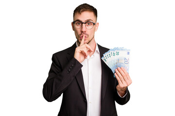 Young business caucasian man holding euro banknotes isolated cut out keeping a secret or asking for silence.