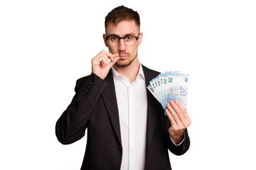 Young business caucasian man holding euro banknotes isolated cut out with fingers on lips keeping a secret.