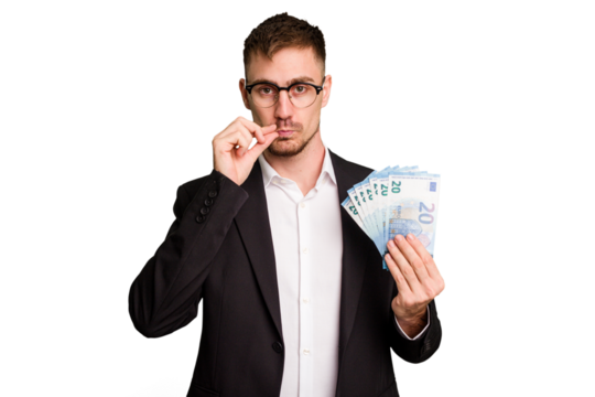 Young business caucasian man holding euro banknotes isolated cut out with fingers on lips keeping a secret.
