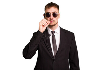 Security bodyguard man wearing a suit isolated cut out with fingers on lips keeping a secret.