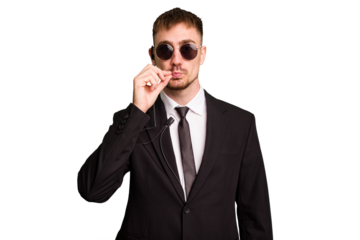 Security bodyguard man wearing a suit isolated cut out with fingers on lips keeping a secret.