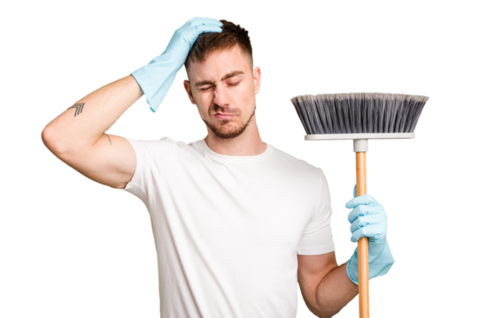 Young man holding a broom to clean his house cut out isolated being shocked, she has remembered important meeting.