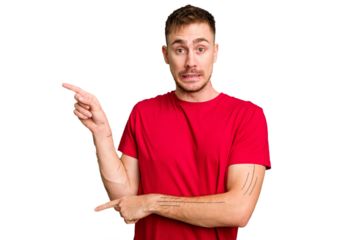 Young caucasian man cut out isolated shocked pointing with index fingers to a copy space.