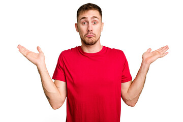 Young caucasian man cut out isolated doubting and shrugging shoulders in questioning gesture.