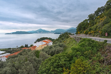 Fototapeta na wymiar Mountain road running along the sea with a beautiful view. Traveling by car in Montenegro.