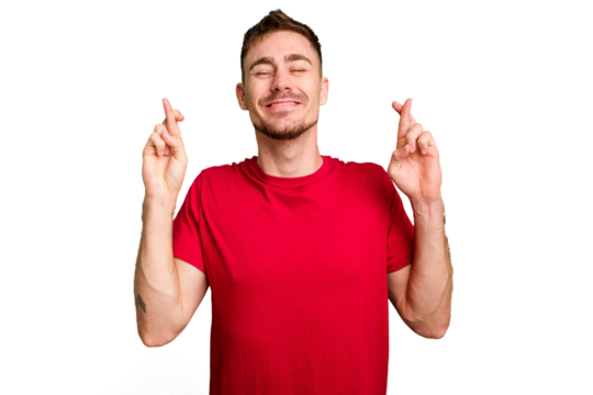 Young caucasian man cut out isolated crossing fingers for having luck - Powered by Adobe