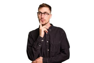 Young caucasian man cut out isolated contemplating, planning a strategy, thinking about the way of a business.