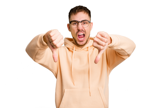 Young caucasian man cut out isolated showing thumb down and expressing dislike.