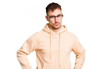 Fototapeta premium Young caucasian man cut out isolated frowning face in displeasure, keeps arms folded.