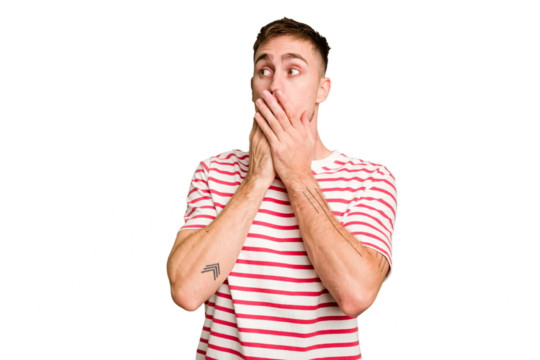 Young caucasian man cut out isolated thoughtful looking to a copy space covering mouth with hand.