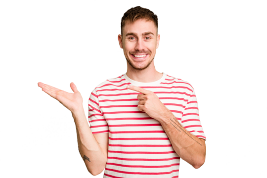 Young caucasian man cut out isolated excited holding a copy space on palm.