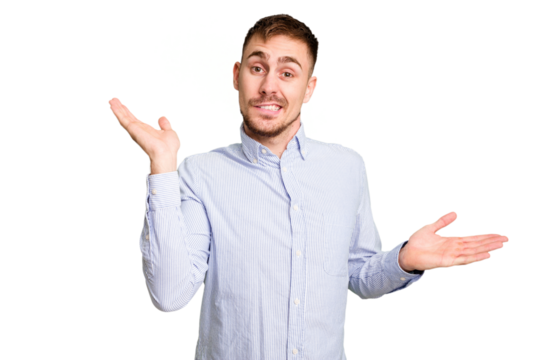 Young caucasian man cut out isolated confused and doubtful shrugging shoulders to hold a copy space.