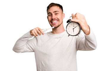 Young man holding an electric brush and an alarm clock cut out isolated